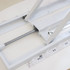 A white backlit LED spring-up display frame with adjustable components and buttons for operation.
