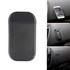 A black dashboard mat with a textured surface, designed to hold small items like phones and keys in place.