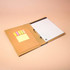An A4 padfolio featuring a brown exterior, lined notepad, and compartments for sticky notes and documents.