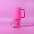 A pink tumbler with a handle and straw, featuring a clear lid, set against a pink background.