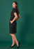 A women's short sleeve dress in black, featuring a fitted silhouette and pockets, displayed against a green background.