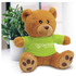 A plush teddy bear with a brown fur, wearing a green shirt and sitting next to a small potted plant.