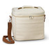 A cream-coloured cooler bag with a zippered top, a handle, and an adjustable strap. It features a front pocket and branding.