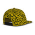 A flat peak cap with a vibrant yellow and black abstract pattern. It features a logo on the back.