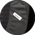 A close-up of a black fabric section featuring a small Osprey logo tag.
