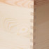 A large wooden storage box with a natural wood finish, featuring detailed dovetail joints.