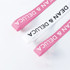 Ribbed fabric ribbon in pink and white, featuring a logo, suitable for various decorative uses.