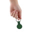 A green Air Tag protective case with a keyring, held in a hand against a white background.