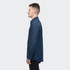 A denim button-up shirt in dark blue, featuring a collar and long sleeves, displayed on a model in profile.