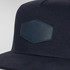 A navy flat peak cap featuring a textured patch and a logo on the front. The design is sleek and modern.