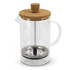 A glass coffee plunger with a cork lid, metal filter, and a black handle, designed for brewing coffee or tea.
