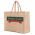 A large, natural-coloured juco bag with sturdy handles and a logo on one side.