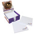 A box containing white notepads, with some stacked inside and others displayed, featuring a logo on the corner.
