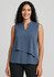 A sleeveless layered blouse in a soft blue hue, featuring a v-neckline and loose fit. The model is smiling, showcasing the top.