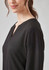 A black long sleeve blouse with a subtle ruché texture, featuring a V-neckline and soft fabric.
