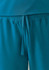 A close-up of teal unisex scrub pants featuring an elastic waistband and drawstring. The fabric appears soft and flexible.