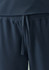 A close-up of navy women's jogger scrub pants featuring an elastic waistband and drawstring detail.