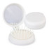 A compact white brush with a mirror, featuring an array of bristles inside its open lid.
