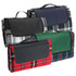 A selection of picnic rugs in navy, green, red, and black plaid, each featuring a carrying handle.