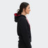 A unisex hoodie in black with a contrasting red hood, featuring a logo on the front.