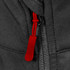 A close-up of a black soft shell jacket featuring a red zip pull and a visible zipper. The jacket has a logo.