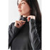A model wears a black Women's Augusta 1/4 Zip Long Sleeve jumper featuring a mock neck and long sleeves.
