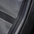 A close-up view of the interior fabric and zip of a black men's softshell jacket, featuring a logo.