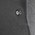 A close-up of a black button on a grey fabric, featuring a simple embossed design.