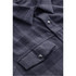 A dark plaid button-up shirt featuring a snap front and two chest pockets. Includes a logo on the label.