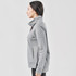A grey women's cowl neck pullover jumper, featuring a high collar and side pockets, displayed on a model from the side.