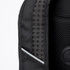 Close-up of a black backpack featuring a textured mesh panel and a circular branding logo.