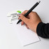 A telephone-shaped notepad in white with lined pages and a black pen resting on it. Features a logo at the top.