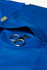 A blue women's scrub top with a pocket containing a pair of scissors and featuring a logo.