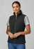 A women's plain micro fleece vest in black, featuring a front zipper and a high collar. Model wears a grey shirt underneath.