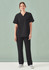 A woman wearing a black unisex pulse V-neck scrub top paired with matching black scrub pants, standing against a light background.