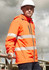 A bright orange packable rain jacket with reflective stripes, worn by a model on a construction site.