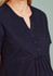 A women's navy tunic scrub top featuring a notch neckline and button detail. The top has a relaxed fit.