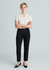 A model wearing women's black slim leg pants and a white short-sleeved top, standing with arms crossed.
