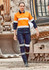 A woman in an orange and navy work outfit with reflective stripes stands near heavy machinery. The outfit includes cargo pants.