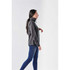 A woman in a grey Catskill Anorak jacket walking side-on, paired with blue jeans. The jacket features a high collar and has a logo.