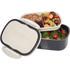 A plastic and wheat straw lunch box in grey and cream, featuring two compartments filled with salads and fruits.