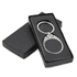 A black leather keychain with a silver metal frame, presented in a sleek black box.