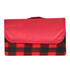 A red and black checkered picnic blanket, folded with a red cover and featuring a logo.