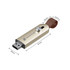A sliding metal flash drive in gold and black, featuring a brown strap and a logo on the side.