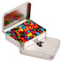 A silver rectangular tin with a hinged lid filled with colourful M&Ms in various shades.