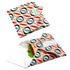 A reusable food wrap with a vibrant geometric pattern in coral, green, and black, featuring a logo.