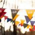 String flags in various colours, including red, yellow, blue, and green, featuring pennant shapes.