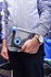 A drink bottle with a transparent design and blue accents, held in a person's hand. It has a logo on the side.