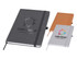 Three A5 notebooks in grey, orange, and white, featuring a logo on the covers and an elastic band closure.