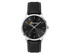 A men's dress watch with a black leather strap and a silver case featuring a black dial and branding.